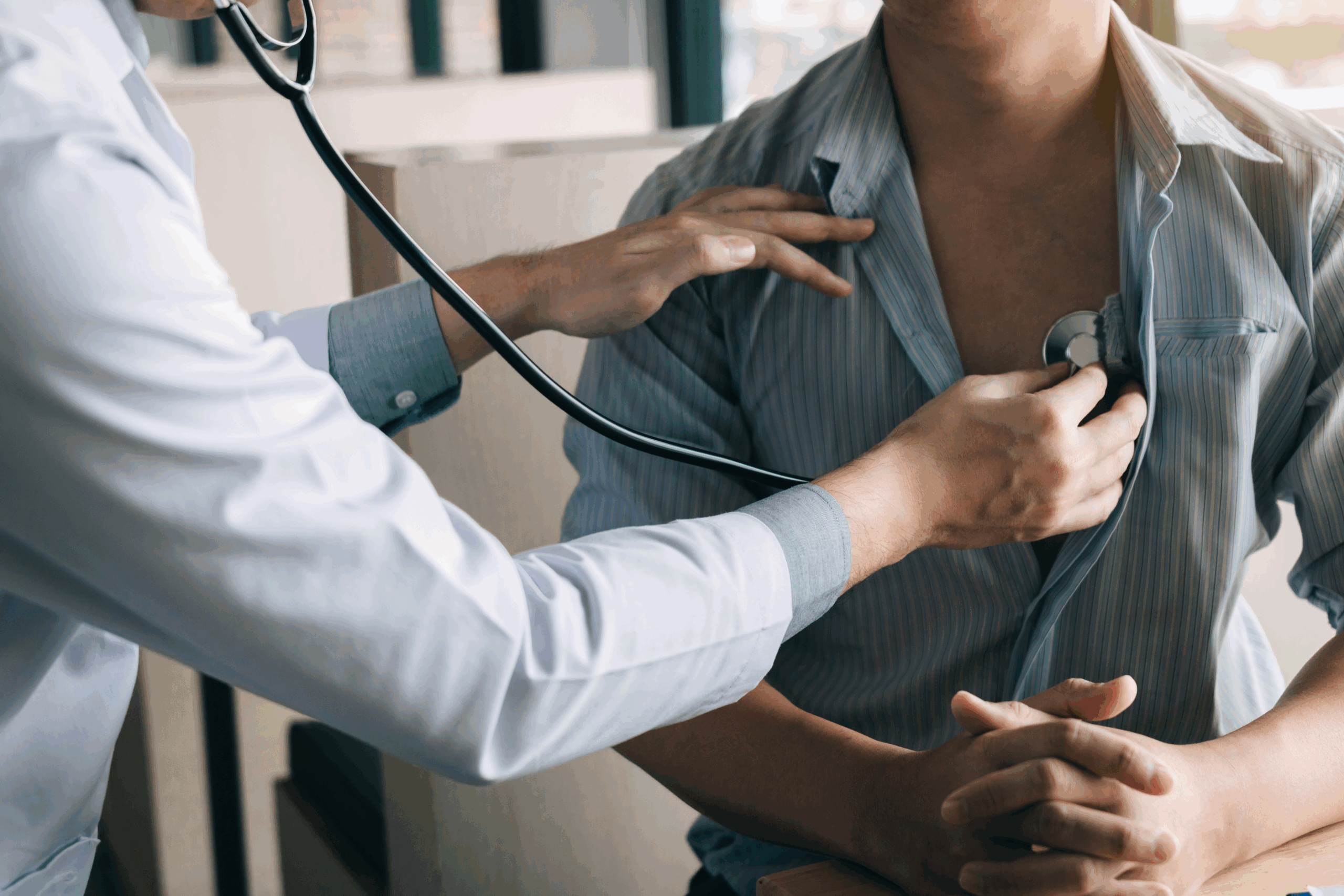 doctor listening to patient's heart
