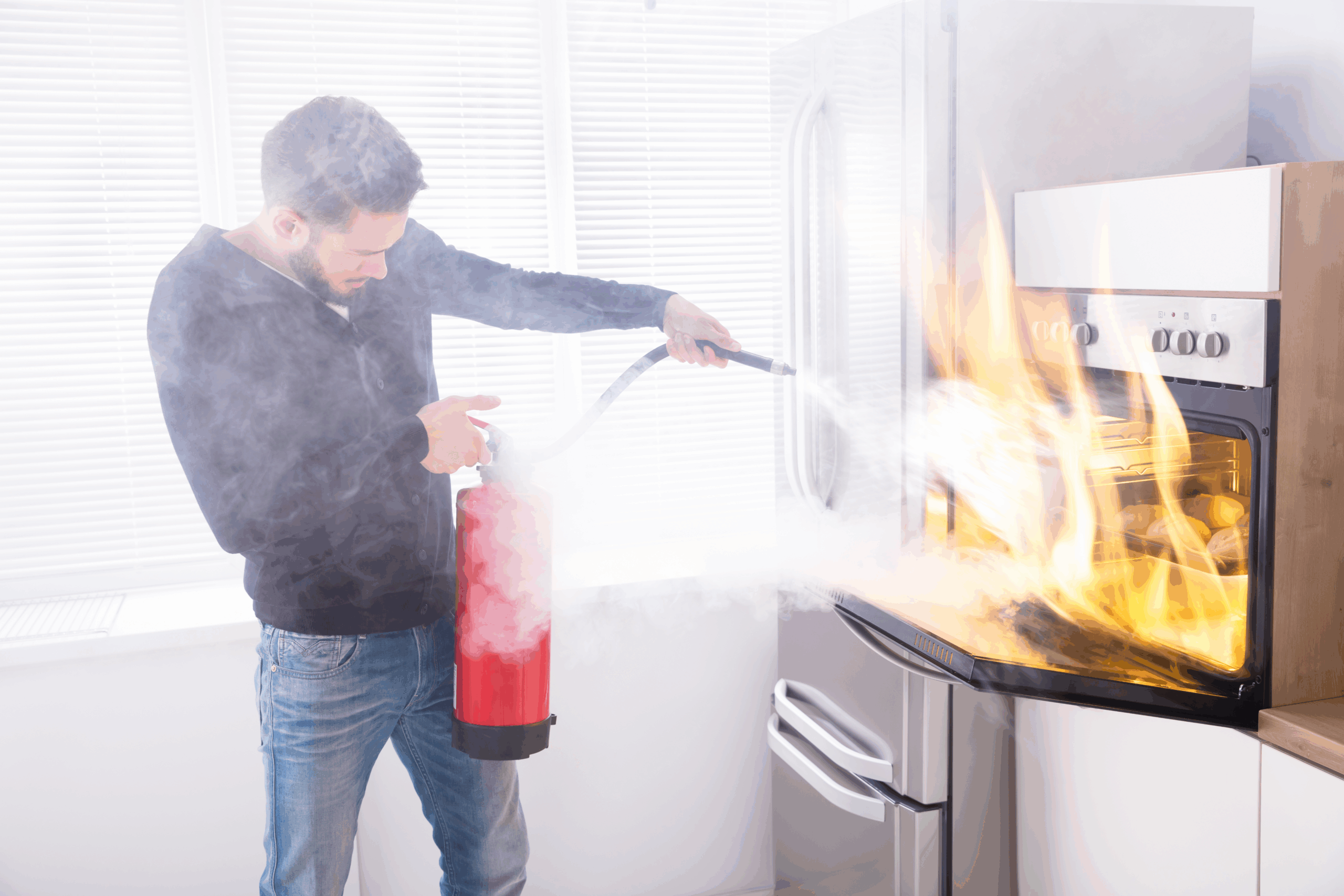 man putting out oven fire